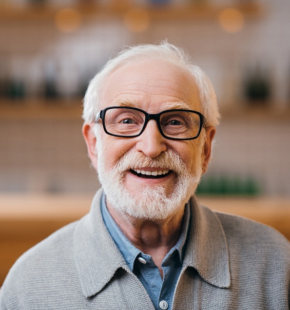 Senior man with beard and glasses smiling
