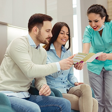 Patients consulting a dentist about insurance options