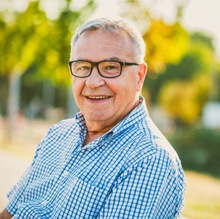 Man with glasses and a patterned shirt