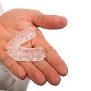 An image of a person holding a customized mouthguard in their hand in West Palm Beach