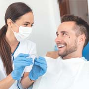 Invisalign dentist in West Palm Beach showing an aligner to a patient