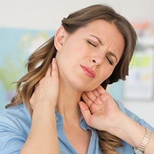 Woman stretching her neck before gum disease treatment