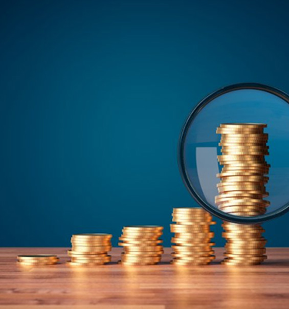 Stacks of coins inspected with magnifying glass