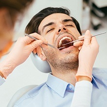 Relaxed man receiving dental care under dental sedation