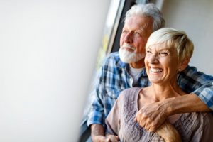 Happy older couple with dental implants in West Palm Beach