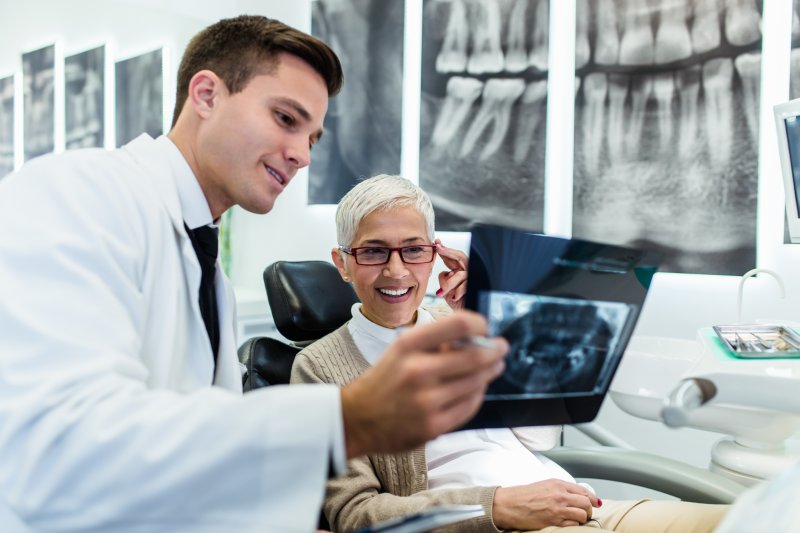 Dentist explaining dental implants in West Palm Beach to patient.