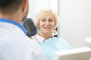 Woman proudly smiling with dental implants