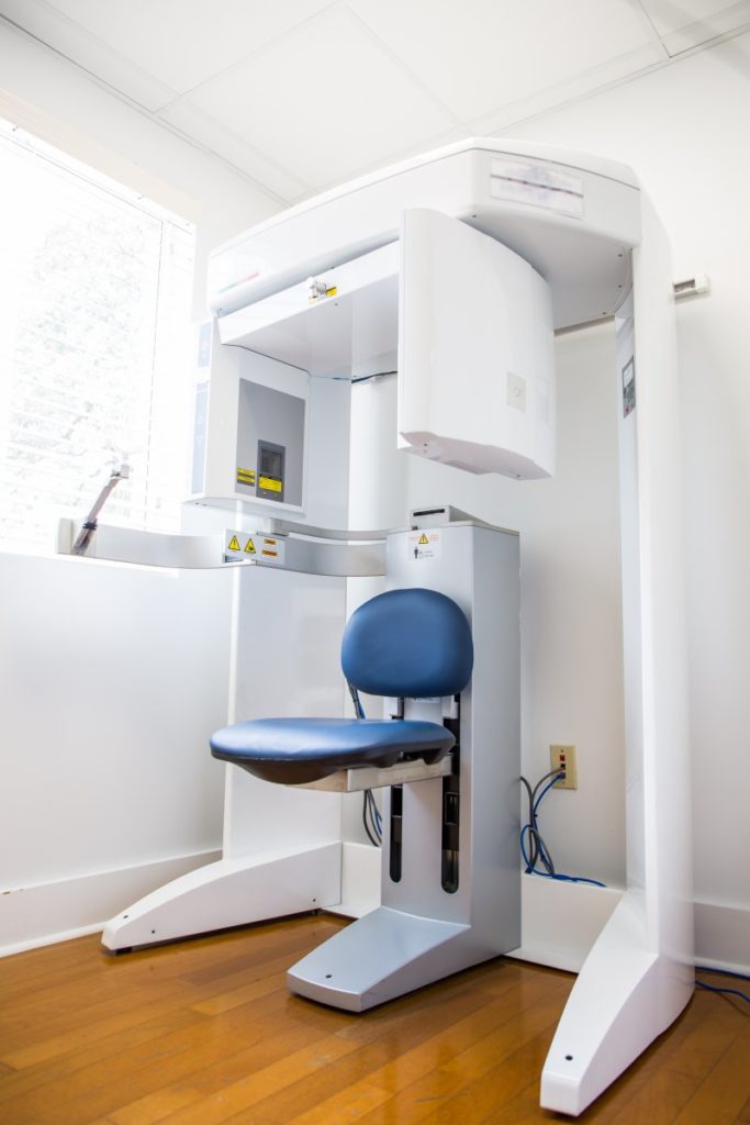 : Cone beam scanner with blue chair in a dental office