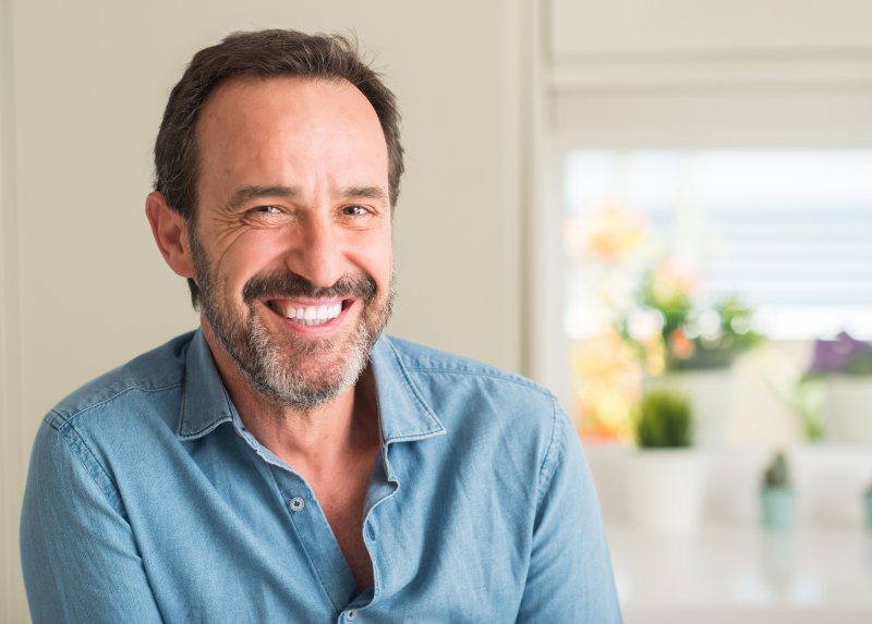 A man smiling with his new dental veneers