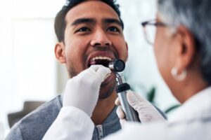 Young man having mouth examined.