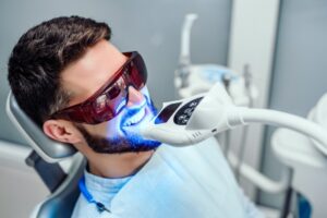 Man having teeth whitening done at dentist's office.